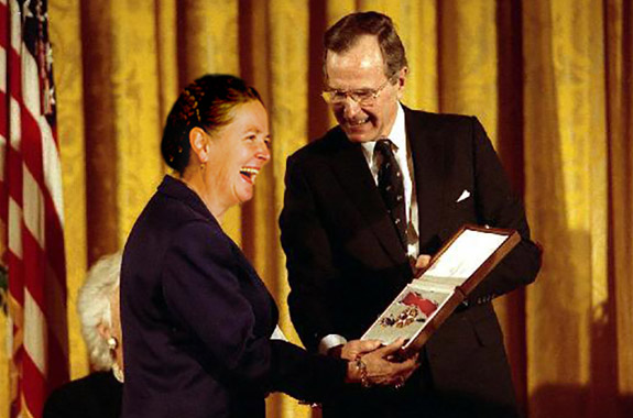 U.S. President H.W. Bush presents American Arkology Society President Sarah Bradderick with an award
